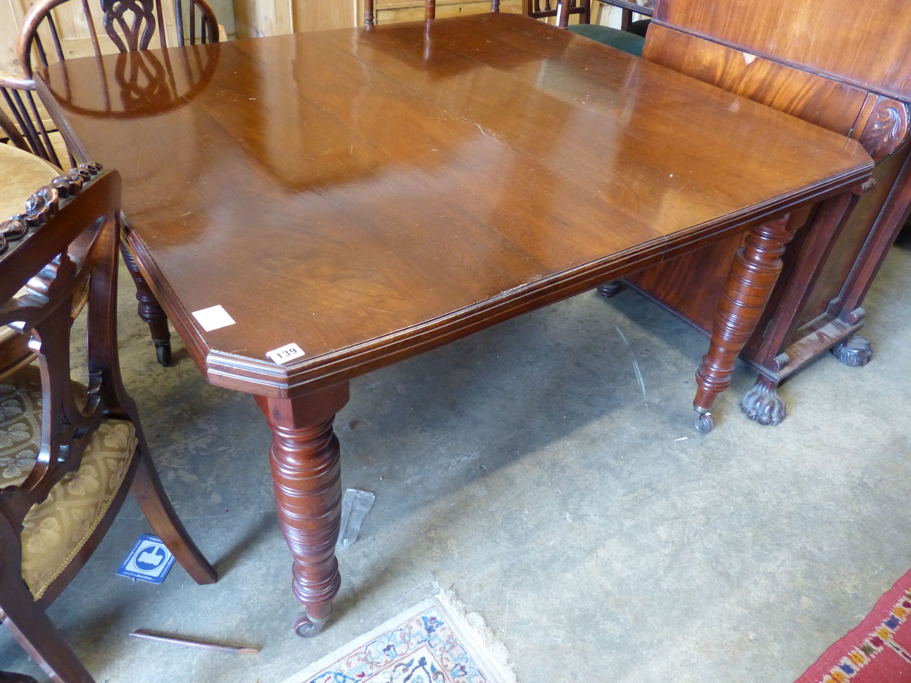 A late Victorian walnut extending dining table, (two spare leaves) 174cm extended, width 114cm, height 73cm.